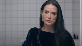 Demi Moore looks into the mirror with tears staining her cheeks